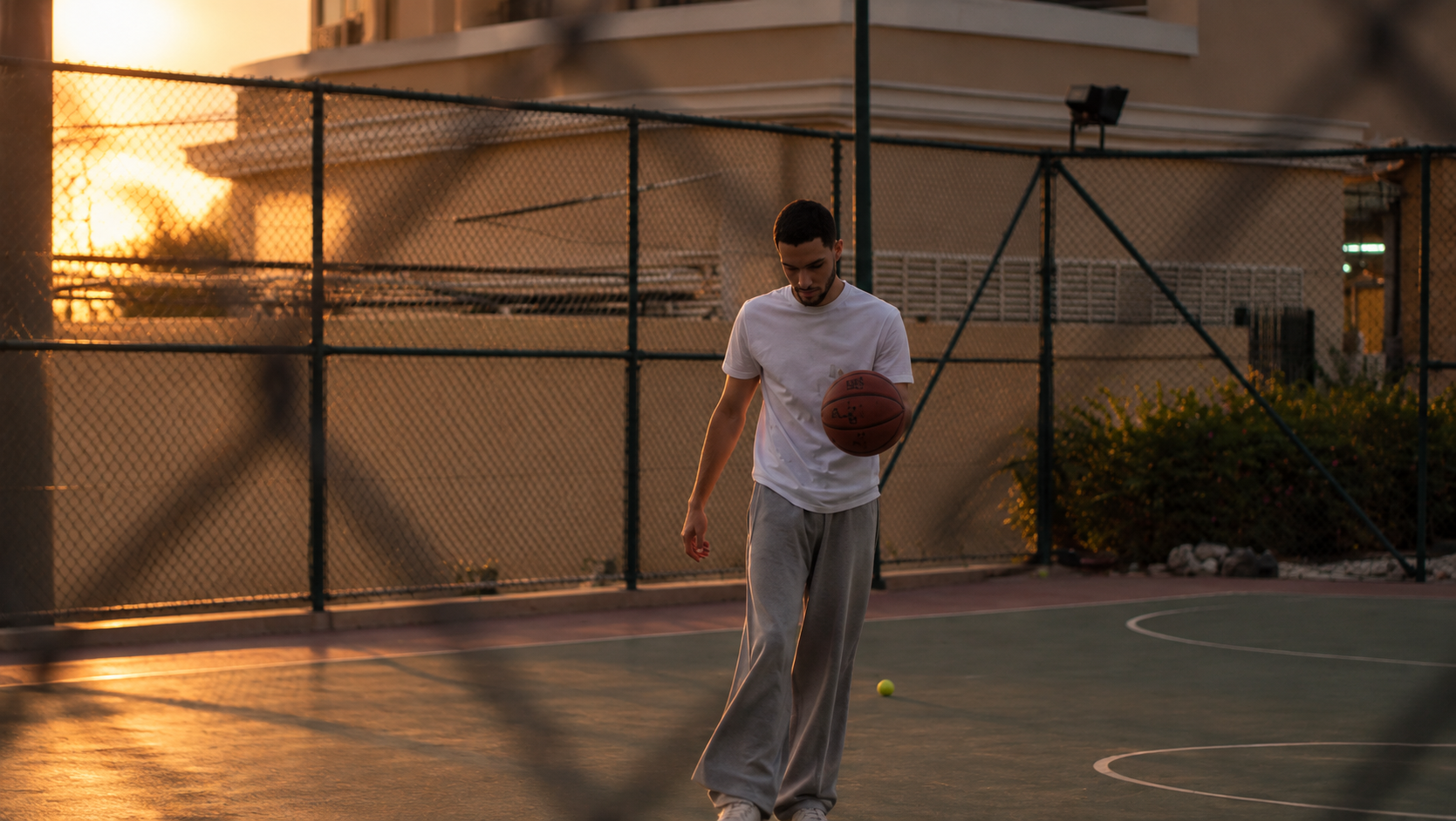 The Stain Theory — basketball court at golden hour